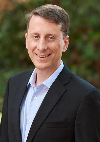 Faculty Director of the Center for Transnational Law and Business, D. Daniel Sokol, stands outside and smiles at the camera.