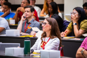 Audience member smiles during Dean Kirschner's lecture to all the Gould Trojan Family Weekend participants