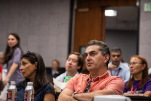 Audience member listens as Professor Rasmussen presents to undergraduate students and their parents about law studies.