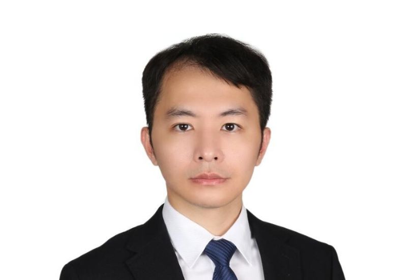 LLM alumnus, Chen-Yun Weng, appears before a white background in business formal attire and looks into the camera.
