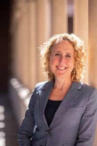 A woman smiles in a corridor